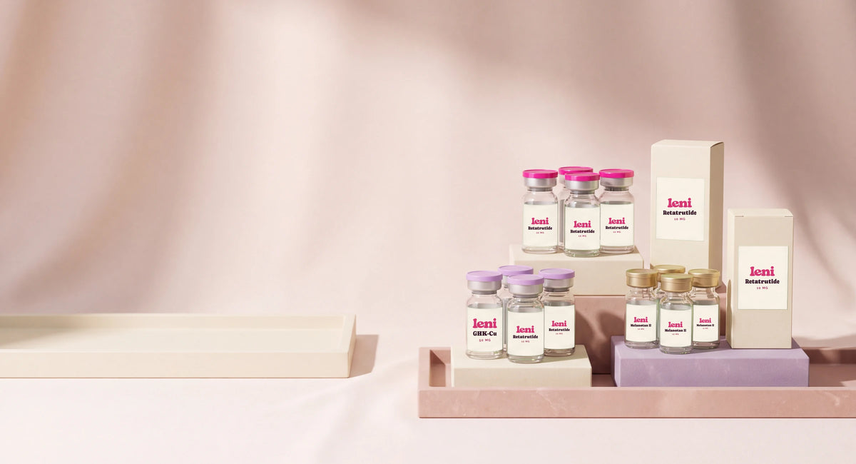Groups of Leni vials and cartons on cream trays and stepped plinths.
