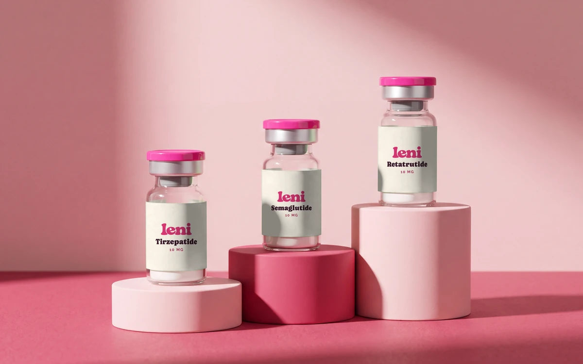 Three Leni vials — Tirzepatide, Semaglutide and Retatrutide — on stepped blush and raspberry plinths.